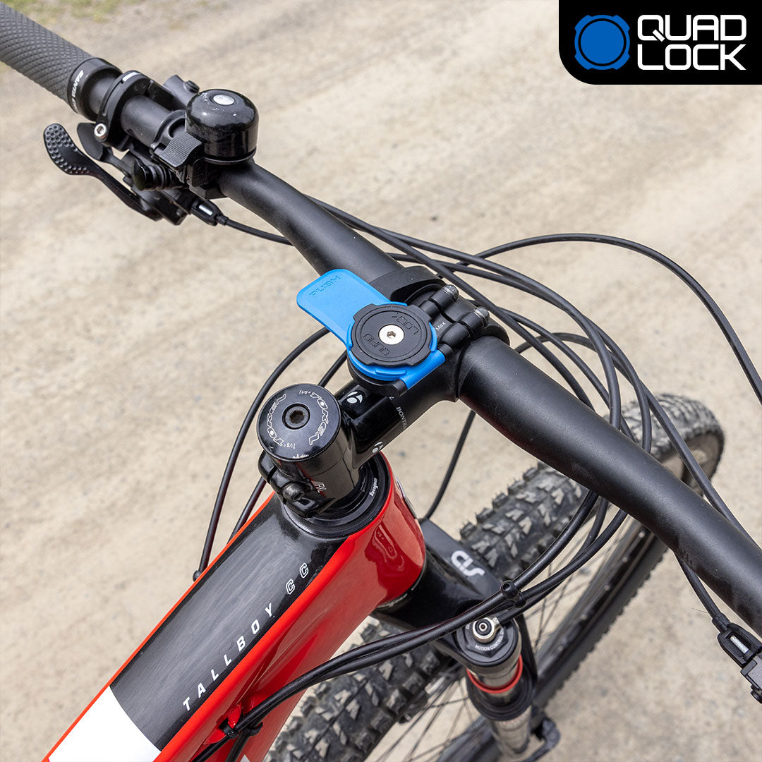 Quad Lock Out Front Mount holding a phone ahead of bike handlebars. Image via Quad Lock.