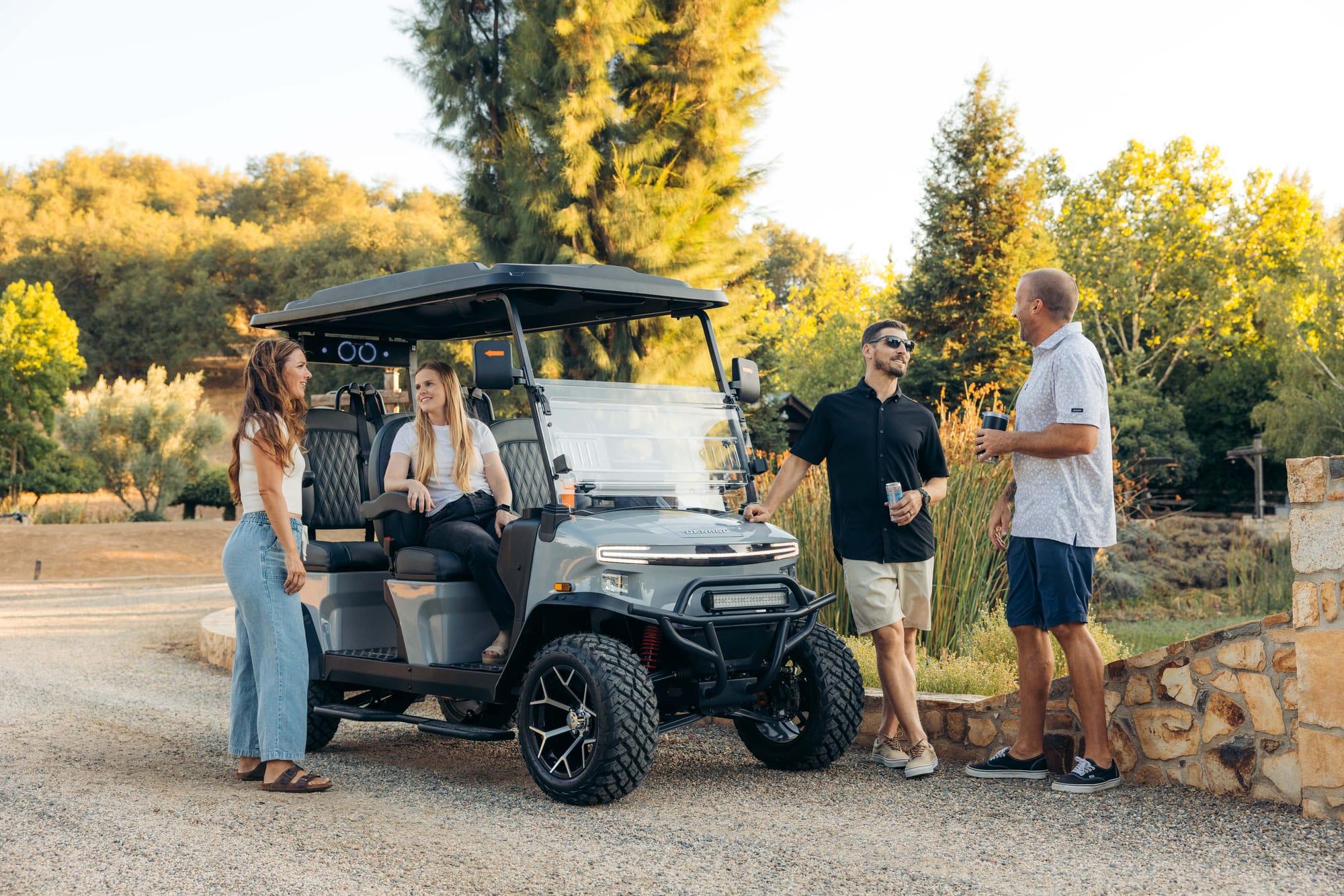 Gray lifted Denago EV Rover XL four-seat street-legal cart on a gravel path. Image via Denago EV.